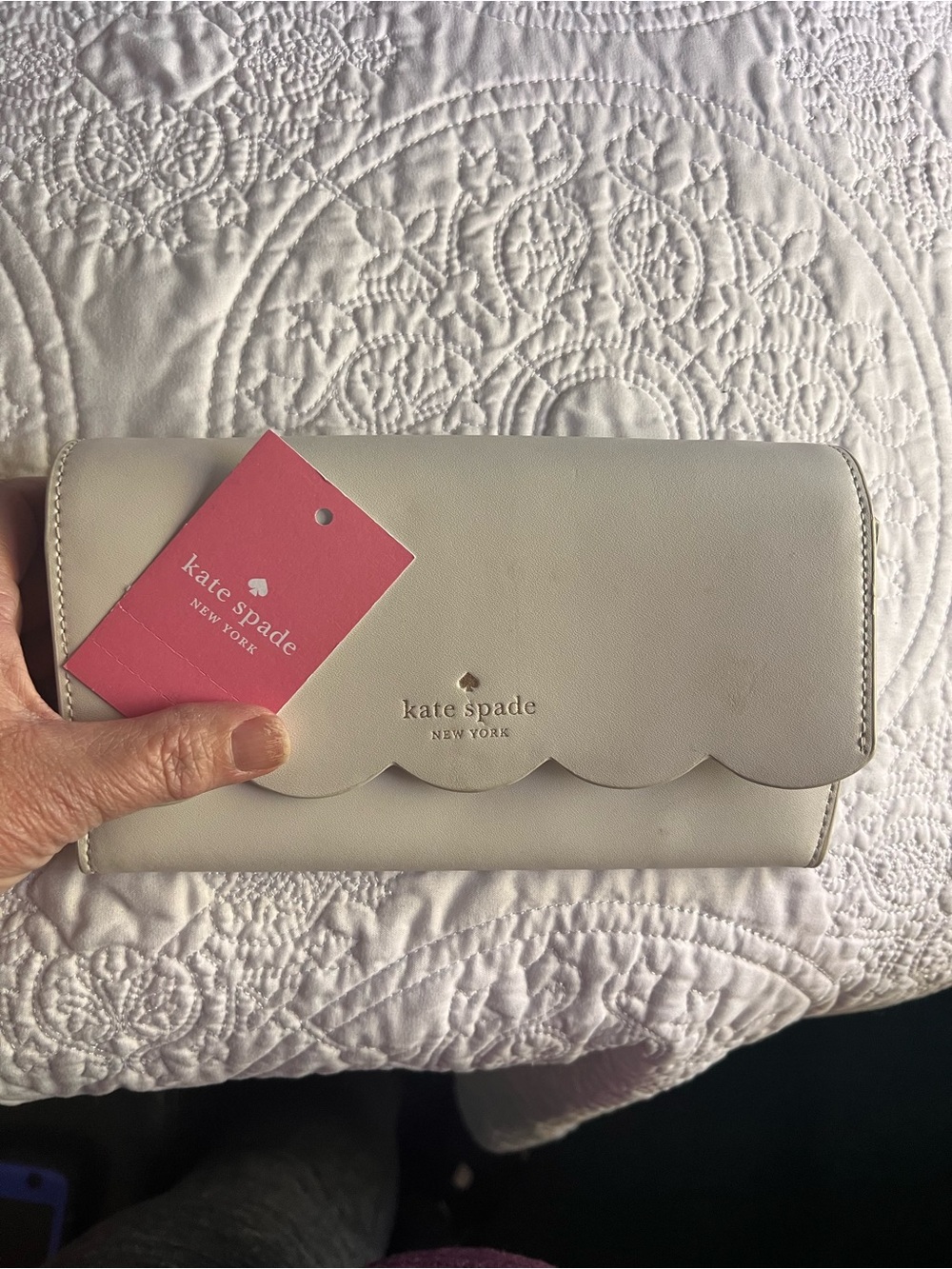 kate spade cream scallop-flap continental wallet with pink tag